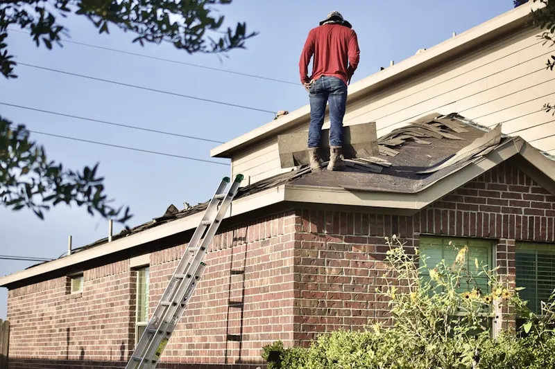 Professional roofer working on a residential roof in Indianola
